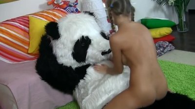 Pigtailed naked cutie plays with dolls to the song 'Barbie Girl'. Here comes a big plush panda and changes the song. It's time to play one more game.